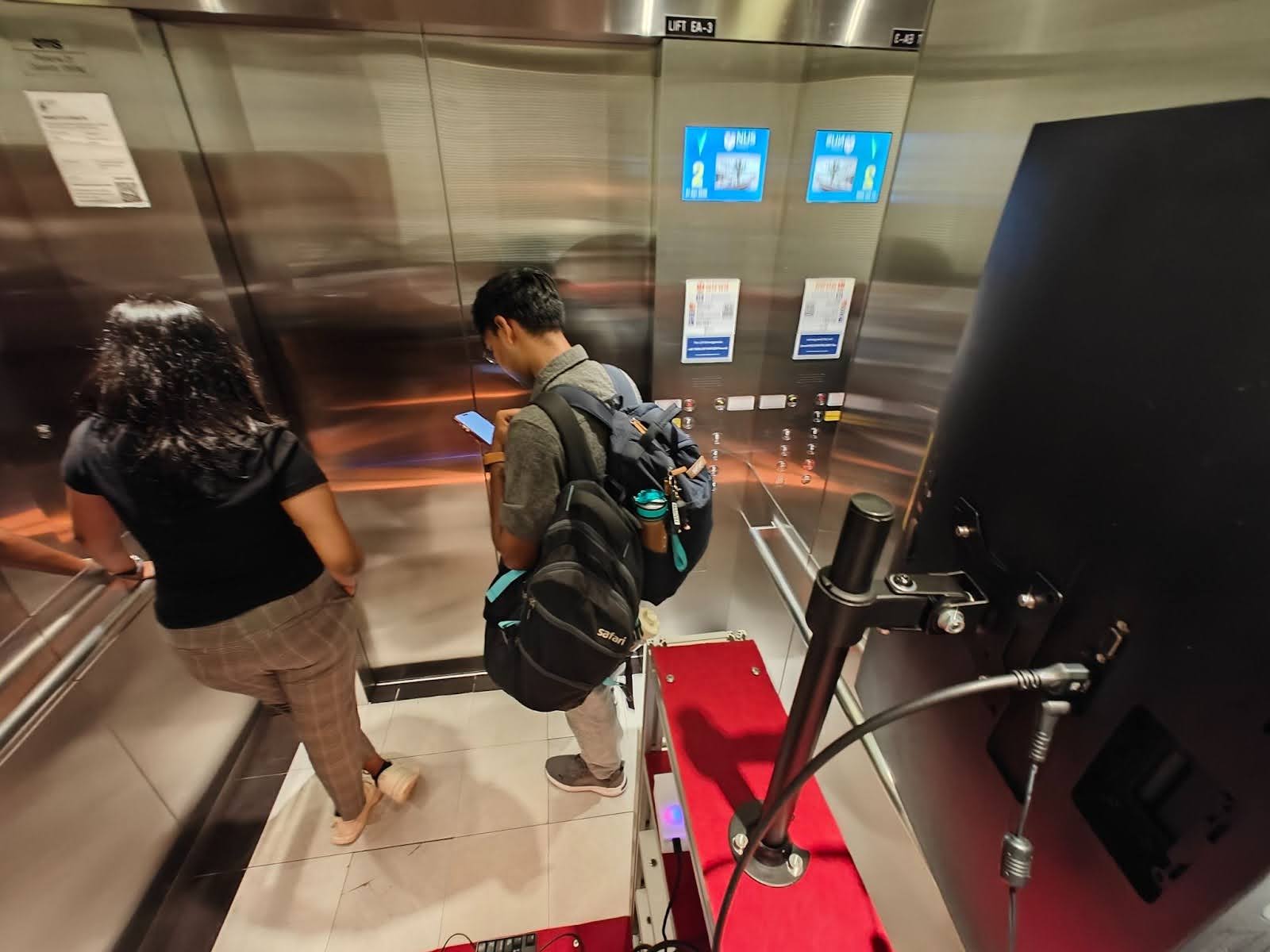 Figure 95: Robot repositioned to face the back wall of the lift — participants visibly more comfortable, occupying more space and displaying less anxious behaviour