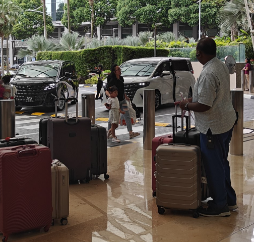 Staff unloading and bundling luggage